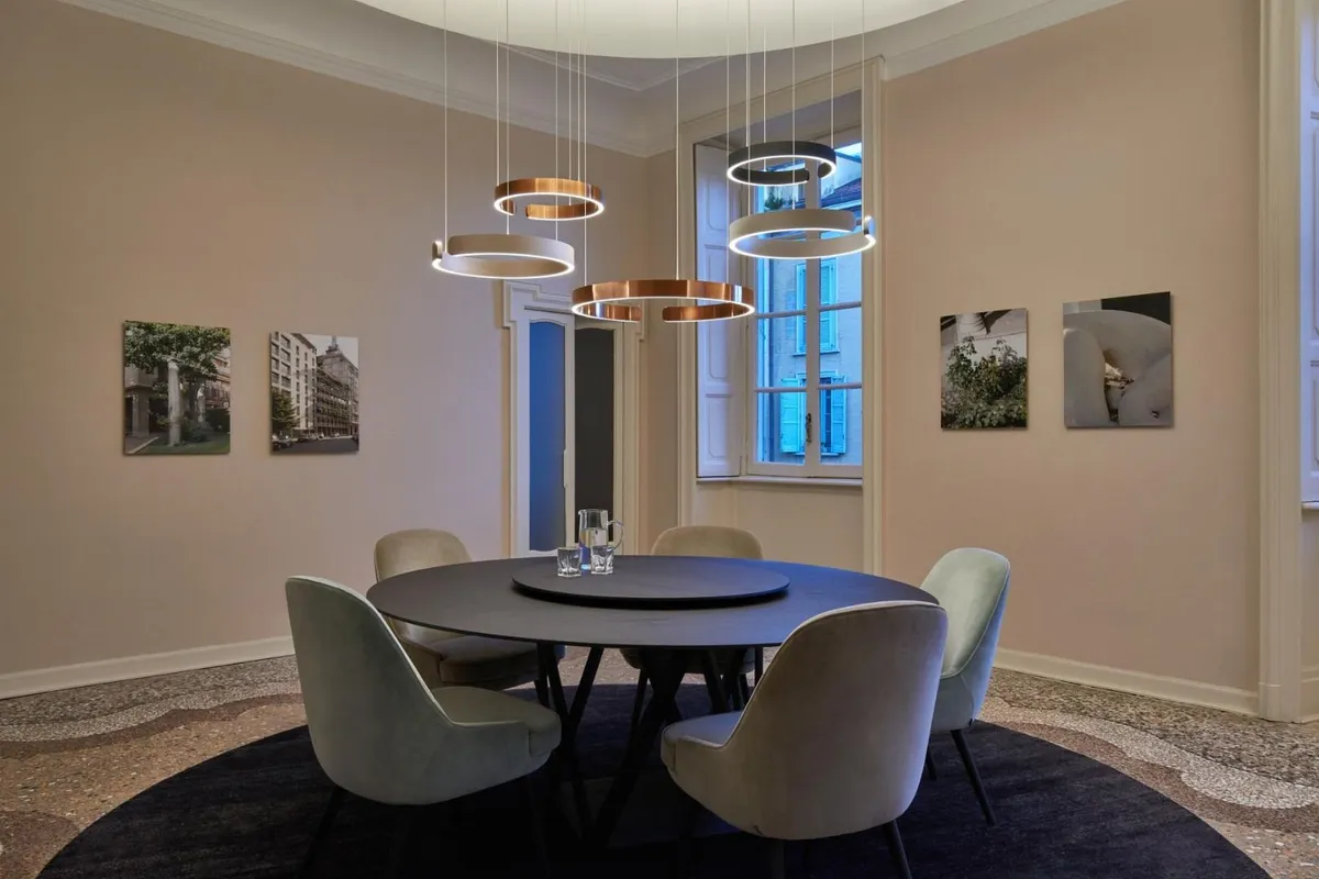 Lampadaire arc et suspension centrale : deux couches de lumière, une seule ambiance.